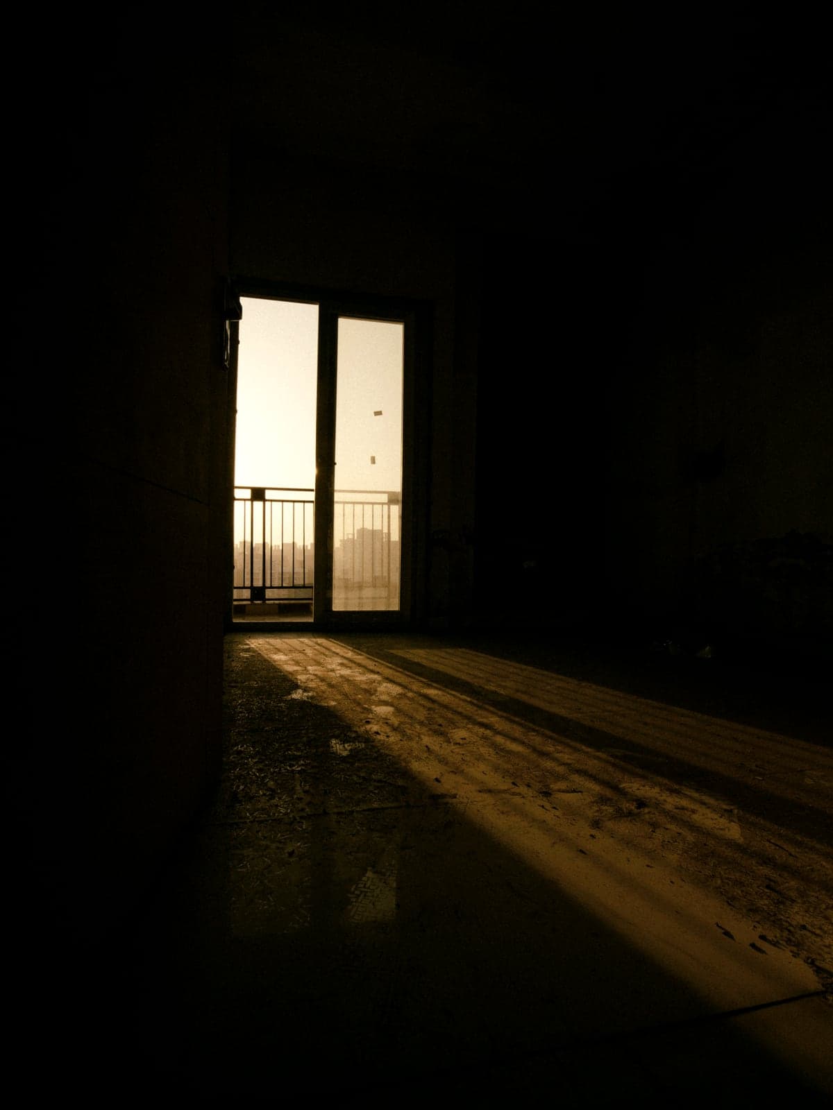 Late daylight falling through an open doorway into a dark room